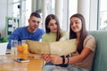 Young caucasian students looking in menu in restaurant Royalty Free Stock Photo