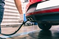 A technician doing an emission control of a security inspection of a vehicle protected with a mask and gloves to prevent the