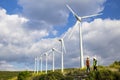 Young engineers looking and checking wind turbines at field Royalty Free Stock Photo