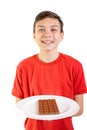 Young caucasian teenage boy with a bar of chocolate Royalty Free Stock Photo