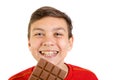 Young caucasian teenage boy with a bar of chocolate Royalty Free Stock Photo