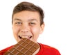 Young caucasian teenage boy with a bar of chocolate Royalty Free Stock Photo