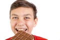 Young caucasian teenage boy with a bar of chocolate Royalty Free Stock Photo