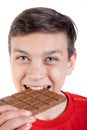 Young caucasian teenage boy with a bar of chocolate Royalty Free Stock Photo