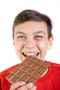 Young caucasian teenage boy with a bar of chocolate Royalty Free Stock Photo