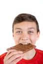 Young caucasian teenage boy with a bar of chocolate Royalty Free Stock Photo