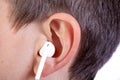 Young caucasian teenage boy`s ear and headphone Royalty Free Stock Photo