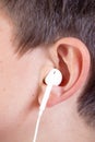 Young caucasian teenage boy`s ear and headphone Royalty Free Stock Photo