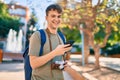 Young caucasian tourist man smiling happy using vintage smartphone at the city