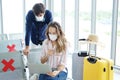 Young Caucasian traveler couple love wear mask for prevention for covid-19 virus is relaxing with laptop for online social media