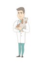 Young caucasian veterinarian with dog in hands.