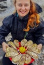 Young Caucasian white woman with red hair holds in her hands a plate with oysters and lemon