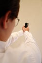 A young caucasian woman aiming a pistol