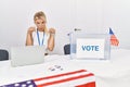 Young caucasian woman at america political campaign election pointing down looking sad and upset, indicating direction with
