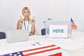 Young caucasian woman at america political campaign election pointing up looking sad and upset, indicating direction with fingers,