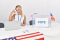 Young caucasian woman at america political campaign election smiling pointing to head with one finger, great idea or thought, good