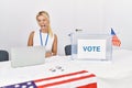 Young caucasian woman at america political campaign election sticking tongue out happy with funny expression