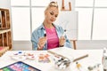 Young caucasian woman artist choosing color pen at art studio Royalty Free Stock Photo