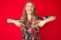 Young caucasian woman with blond hair pointing with fingers to herself winking looking at the camera with sexy expression, Royalty Free Stock Photo