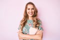 Young caucasian woman with blond hair wearing casual clothes happy face smiling with crossed arms looking at the camera Royalty Free Stock Photo