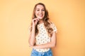 Young caucasian woman with blond hair wearing casual summer clothes smiling looking confident at the camera with crossed arms and Royalty Free Stock Photo