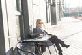 Young caucasian woman business woman drinks coffee at coffee shop terrace