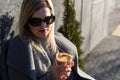 Young caucasian woman business woman drinks coffee at coffee shop terrace