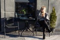 Young caucasian woman business woman drinks coffee at coffee shop terrace