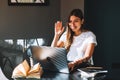 Young woman college student studying with books, laptop distantly at home Royalty Free Stock Photo