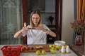 Young caucasian woman cooking fresh fruit and vegetable salad on table. Person preparing healthy yummy eating lunch in Royalty Free Stock Photo