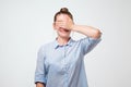 Young caucasian woman covering her eyes. Studio shot Royalty Free Stock Photo