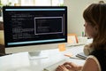 Young Caucasian woman developing neural network code on desktop computer Royalty Free Stock Photo