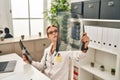 Young caucasian woman doctor looking xray sitting on table at clinic Royalty Free Stock Photo