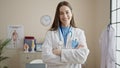 Young caucasian woman doctor smiling confident standing with arms crossed gesture at clinic Royalty Free Stock Photo