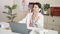 Young caucasian woman doctor talking on phone at clinic Royalty Free Stock Photo