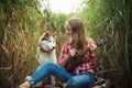 Young caucasian woman with dog playing ukulele Royalty Free Stock Photo