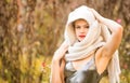 Young caucasian woman in a dress and a headscarf outdoors Royalty Free Stock Photo