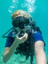 Young caucasian  woman dressed in diving equipment swimming underwater in ionian sea .Greece , Corfu scuba diving in vacation Royalty Free Stock Photo