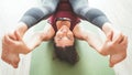 Young caucasian Woman dressed skinny sporty clothes cheerfully smiling into camera doing yoga exercises Ananda Balasana pose on