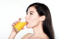 Young caucasian woman drinking orange juice