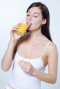 Young caucasian woman drinking orange juice Royalty Free Stock Photo