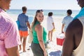 Young Caucasian woman enjoys a sunny beach day with friends Royalty Free Stock Photo