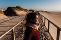 Young caucasian woman with eyes closed relaxing at the beach at sunset. Holidays and relaxation concept Royalty Free Stock Photo