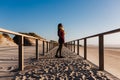 Young caucasian woman with eyes closed relaxing at the beach at sunset. Holidays and relaxation concept Royalty Free Stock Photo