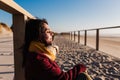 Young caucasian woman with eyes closed relaxing at the beach at sunset. Holidays and relaxation concept Royalty Free Stock Photo