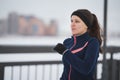 Young caucasian woman fitness model running at snow winter promenade, close up Royalty Free Stock Photo