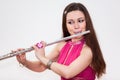 Young Caucasian woman flutist playing on flute,