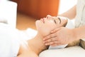 A young Caucasian woman getting a head massage It`s in a spa shop. Yougn Caucasian girl relaxing with hand spa massage at beauty