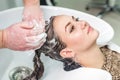 Young caucasian woman getting washing her hair