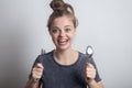 Young caucasian woman girl with spoon and fork in hands, looking excited and hungry. Funny face expression